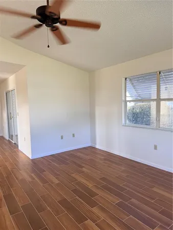 wooden floor in an empty room with a window