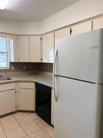 a white refrigerator freezer sitting in a kitchen