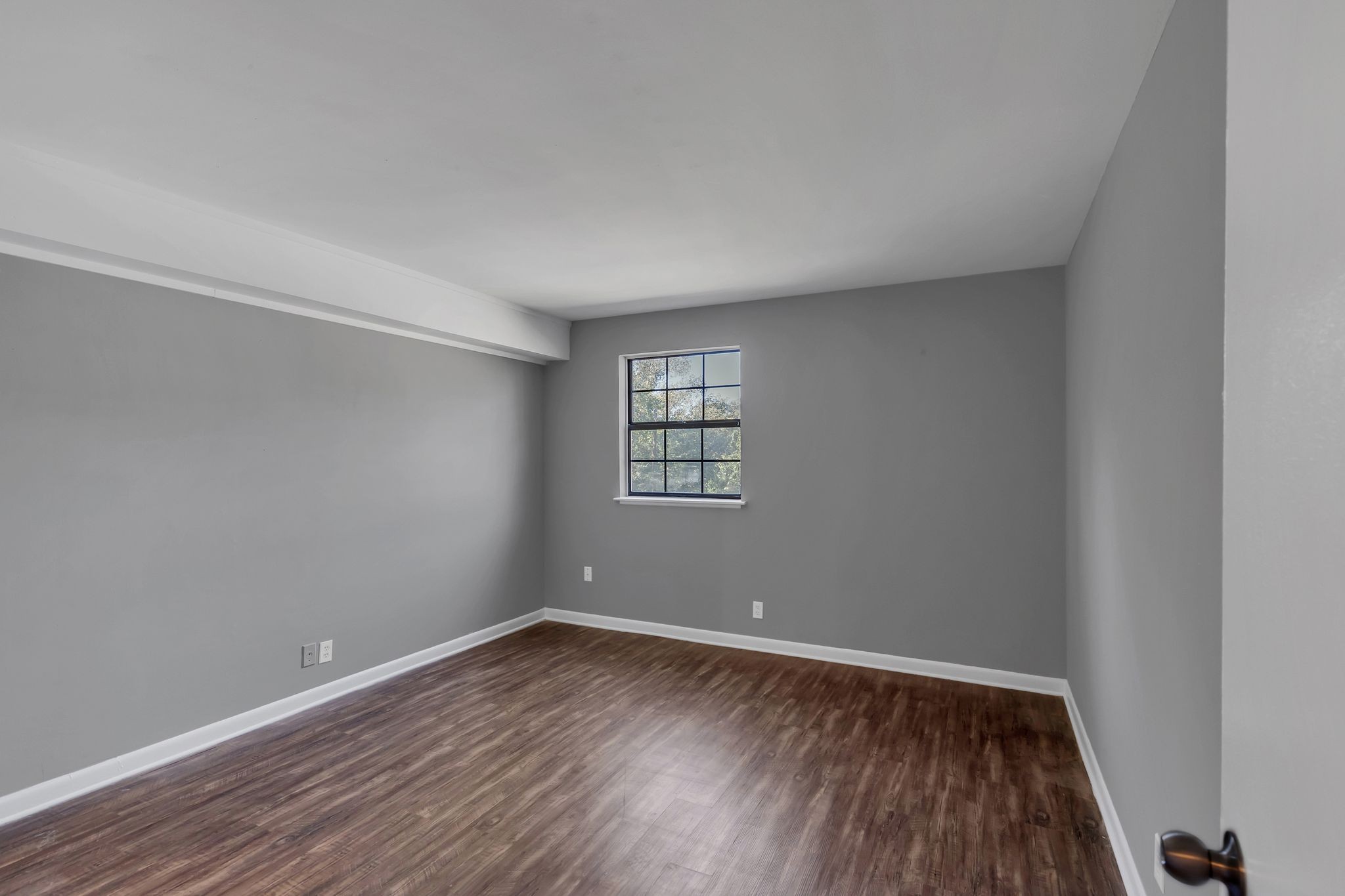 420 Walton Lane, Unit I41 Madison, TN 37115 - Photo 11 of 20 wooden floor in an empty room with a window