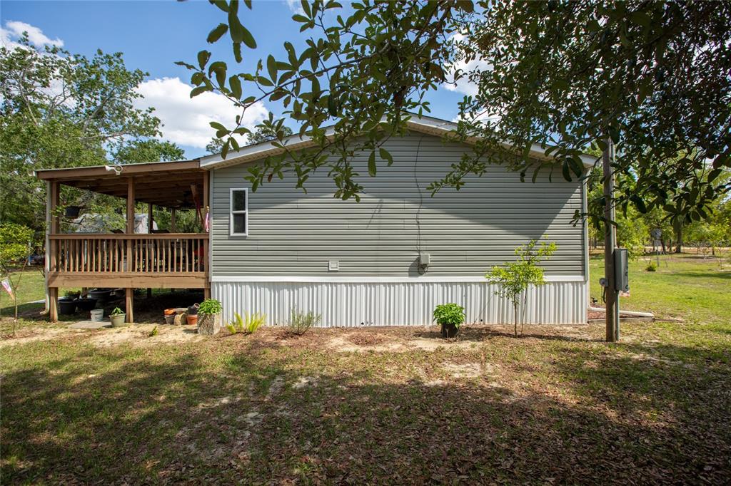 5670 Acadia Street Keystone Heights, FL 32656 - Photo 21 of 65 a front view of a house with a yard