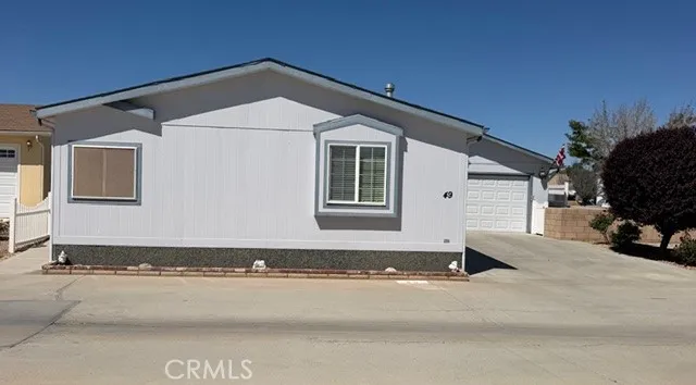 22241 Nisqually Road East, Unit 49 Apple Valley, CA 92308 - Photo 2 of 2 a view of a house with a yard