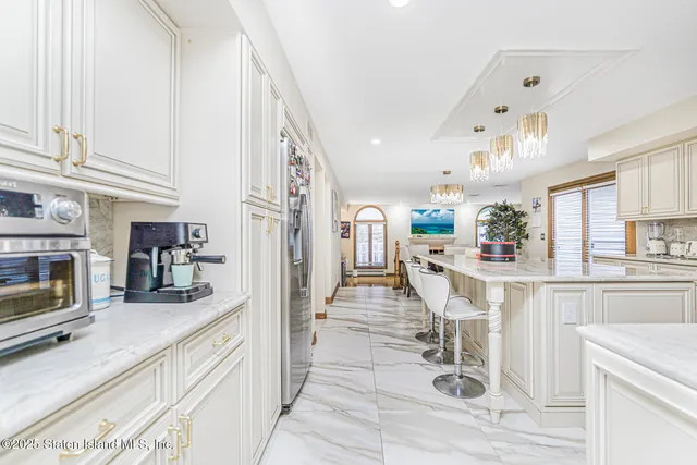 a view of a dining room with furniture a chandelier and wooden floor