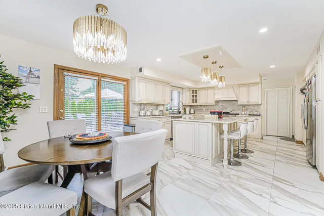 a living room with furniture a window and a dining table