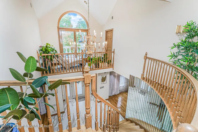 a view of a house with wooden deck and furniture