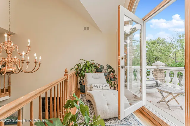 a large white bathroom with a large mirror vanity and a bathtub