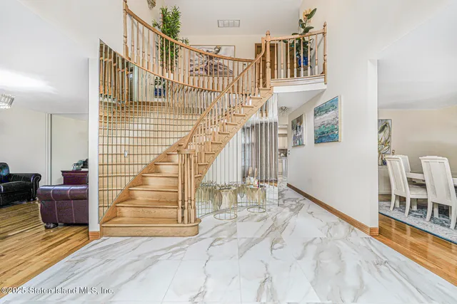 a view of entryway and hall with wooden floor