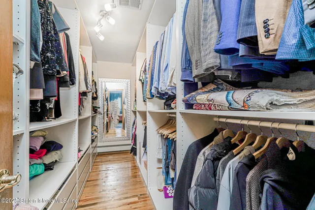 a bedroom with a bed window and dresser
