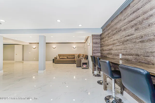 a view of a deck with table and chairs under an umbrella with wooden floor