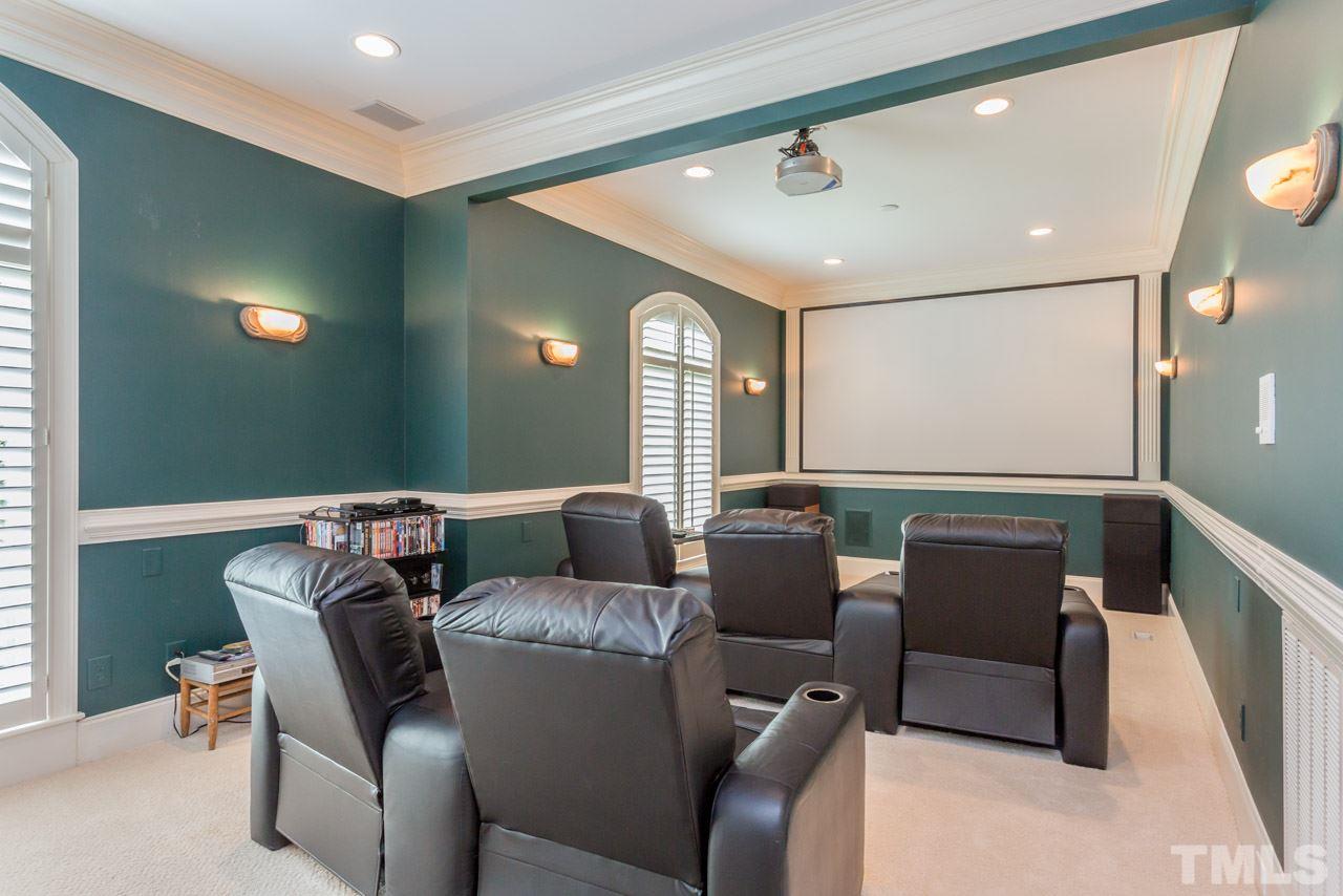 7108 Grist Mill Road Raleigh, NC 27615 - Photo 22 of 25 Friends and family will enjoy gathering in the media room. This versatile space could also be used as a play room,bonus room, or billiard room. It offers plantation shutters, wall sconces, chair rail,&crown molding. A convenient half bath is close by.