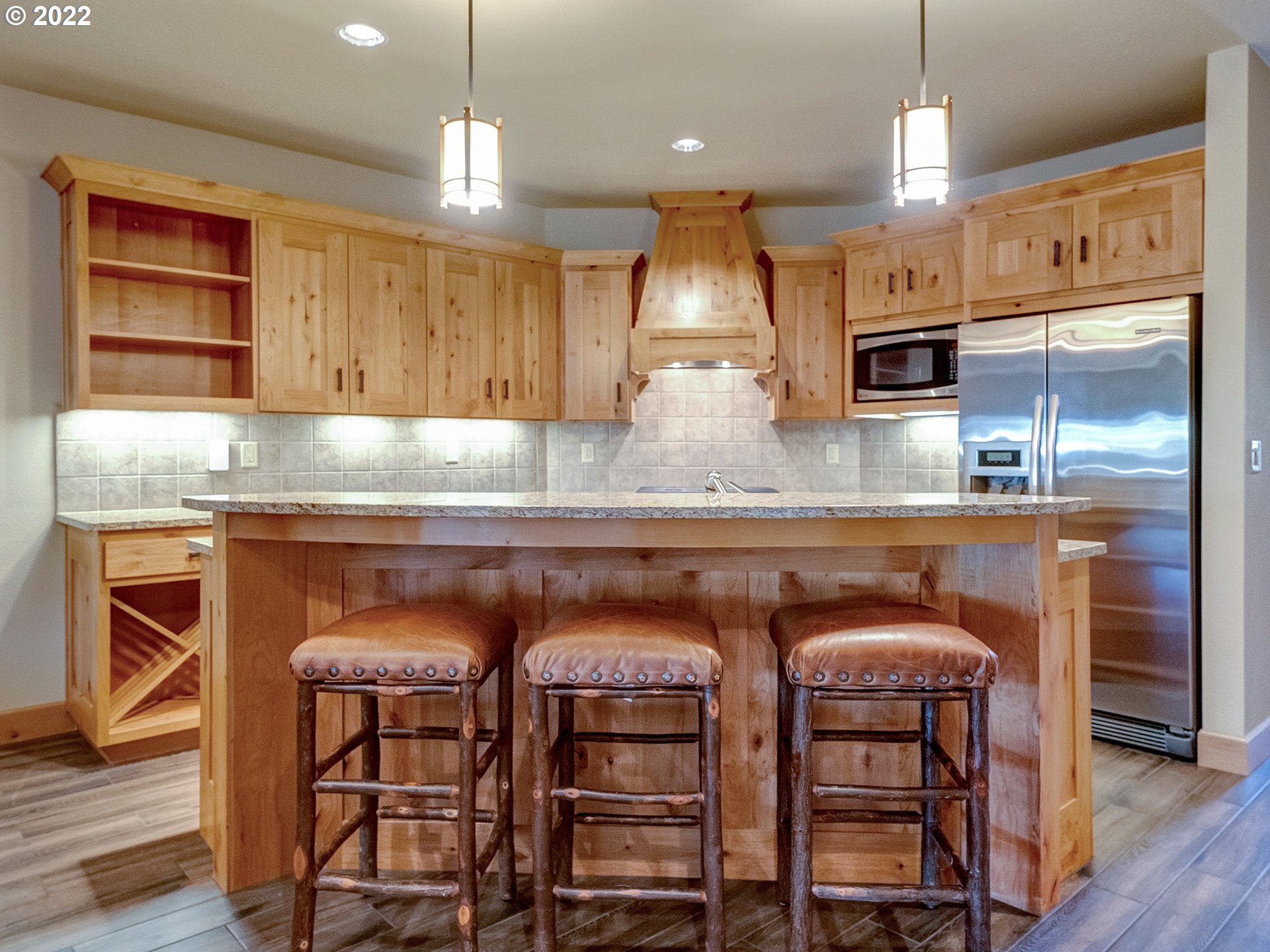 31214 East Collins Lake Road, Unit 18 Government Camp, OR 97028 - Photo 5 of 32 a kitchen with cabinets and wooden floor