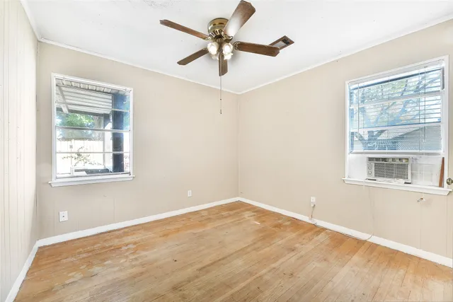 a view of a room with a window and a ceiling fan