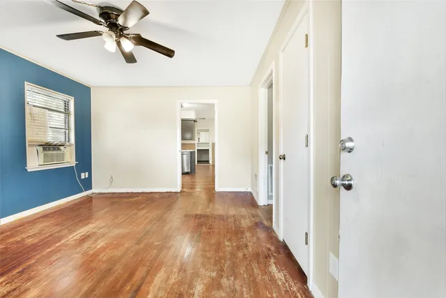 wooden floor in an empty room with a window