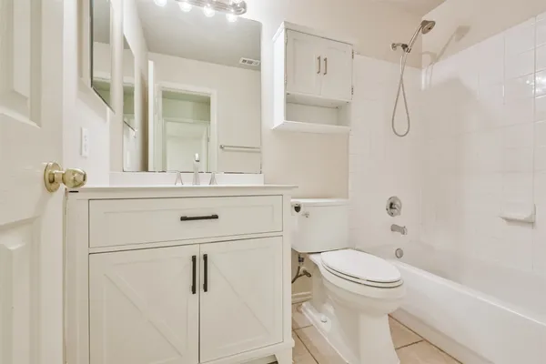 a bathroom with a shower a toilet and sink