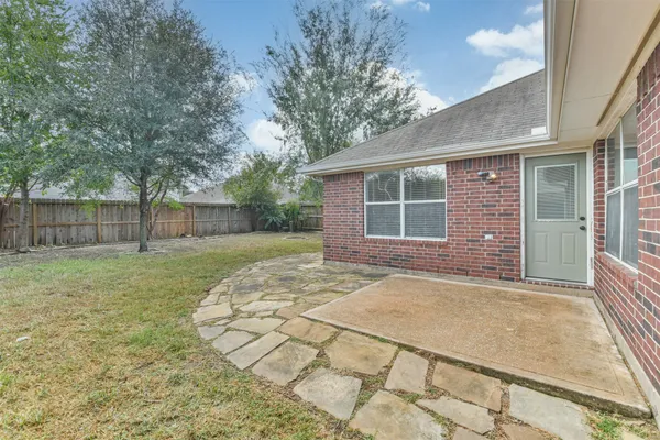 a view of a house with a backyard and a garden