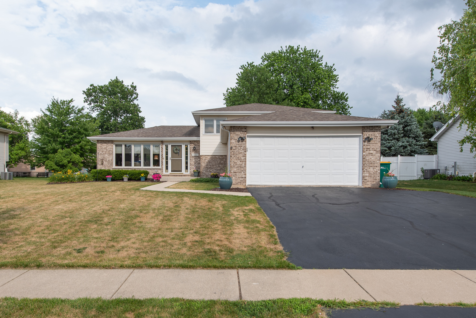 16447 Timberview Drive Plainfield, IL 60586 - Photo 1 of 1 a front view of a house with garden