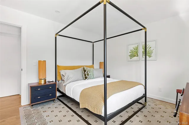 a bedroom with a bed and a mirror