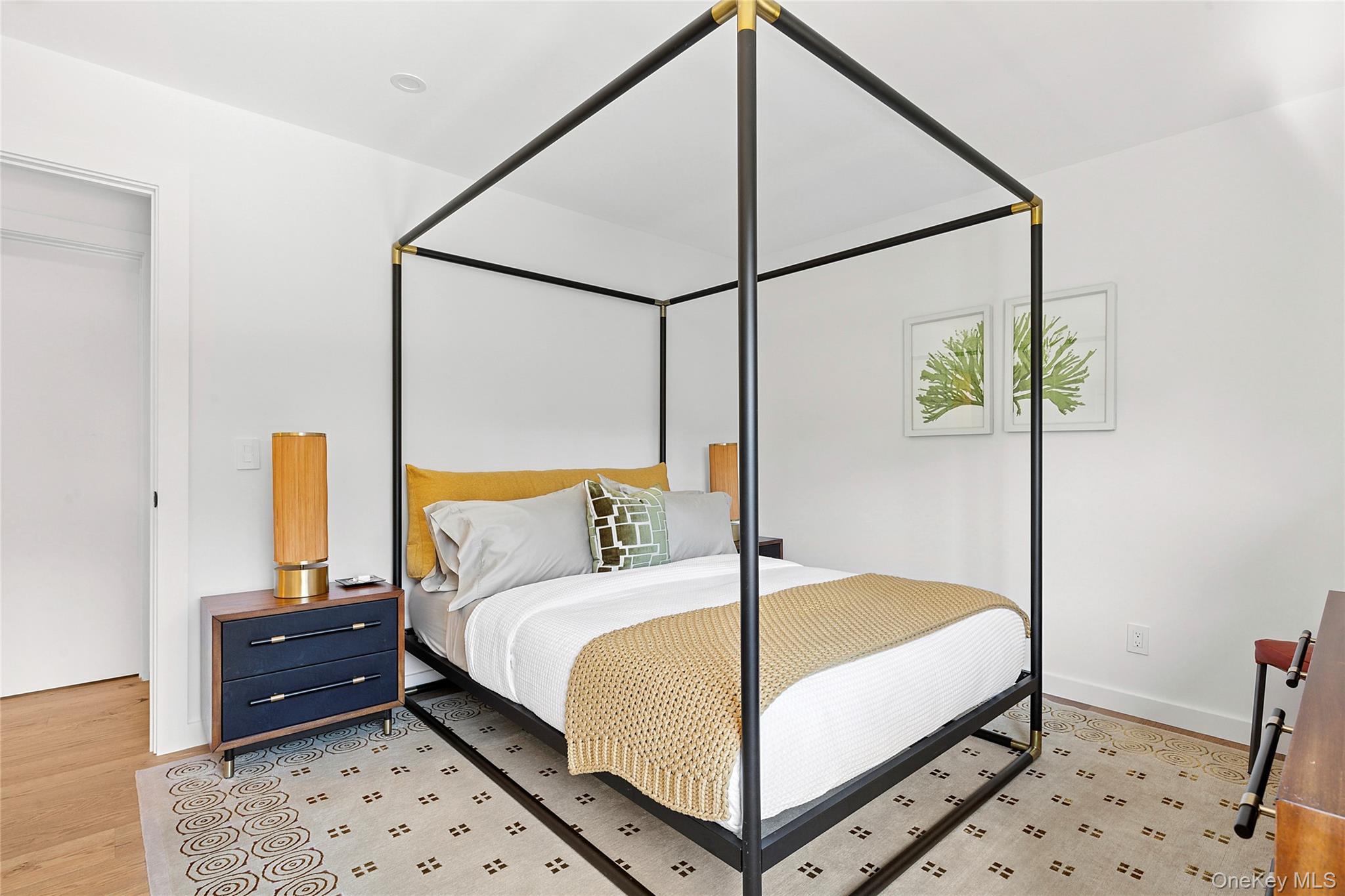 70 Whooping Hollow Road East Hampton, NY 11937 - Photo 11 of 15 a bedroom with a bed and a mirror