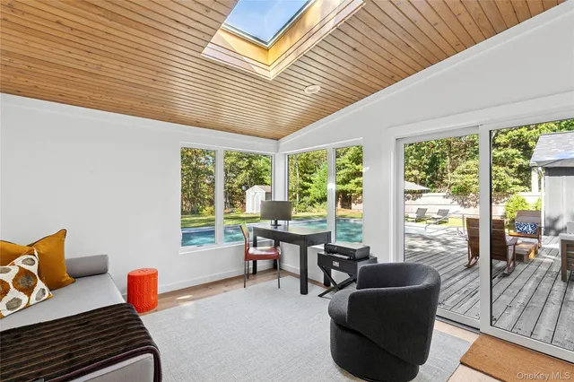 a living room with furniture and a floor to ceiling window