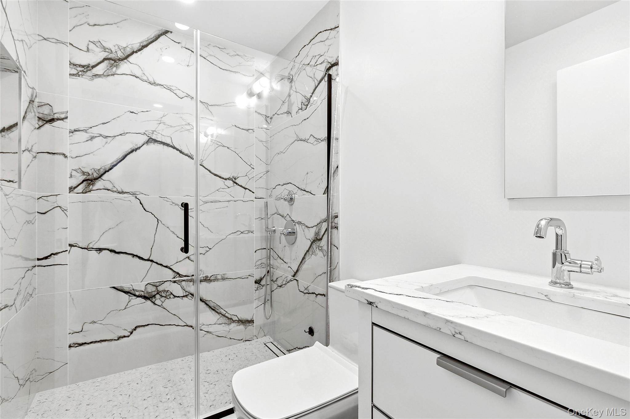 70 Whooping Hollow Road East Hampton, NY 11937 - Photo 15 of 15 a bathroom with a granite countertop sink and a toilet