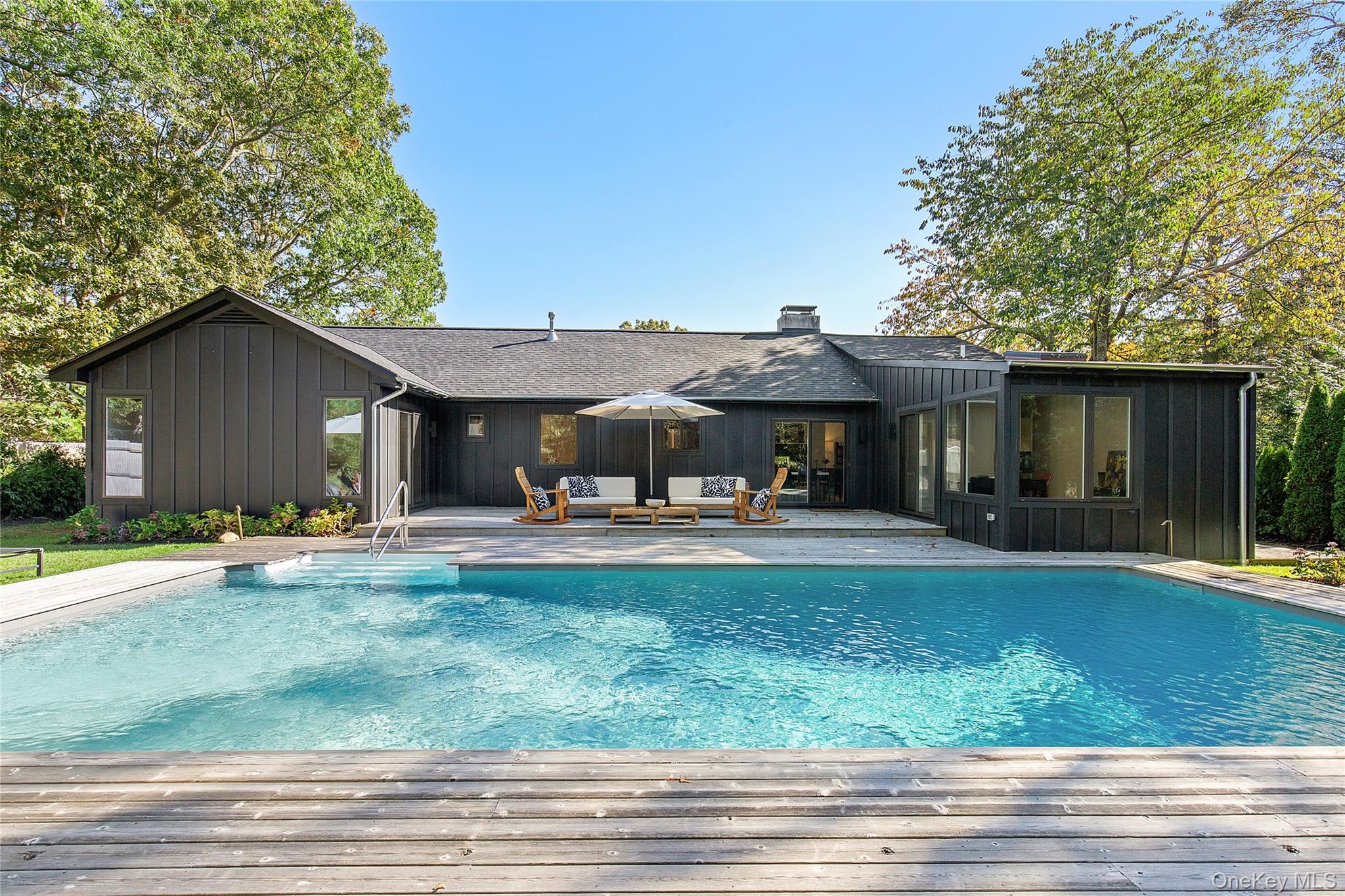 70 Whooping Hollow Road East Hampton, NY 11937 - Photo 2 of 15 a front view of a house with garden and porch