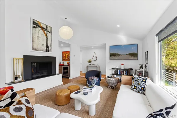 a living room with furniture a fireplace and a flat screen tv
