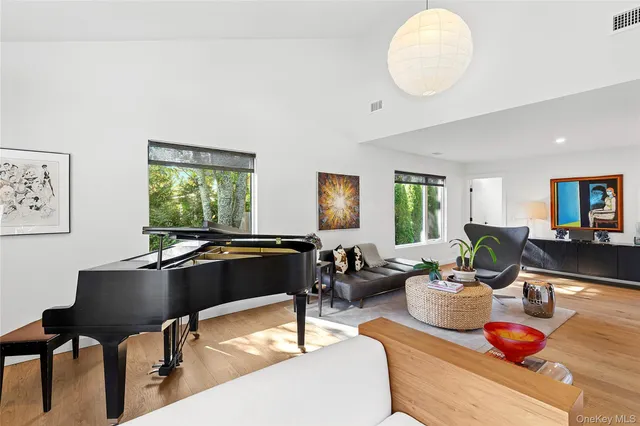 a living room with furniture a window and a potted plant