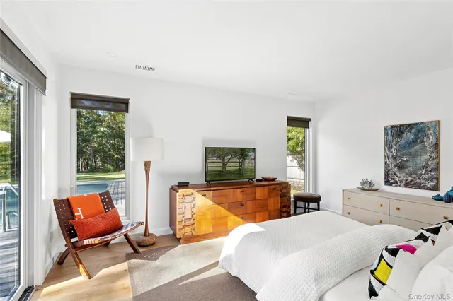a bedroom with furniture and a flat screen tv