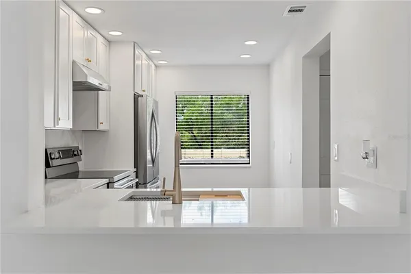 a bathroom with a tub a sink and a large window