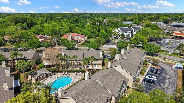 an aerial view of residential houses with outdoor space and street view