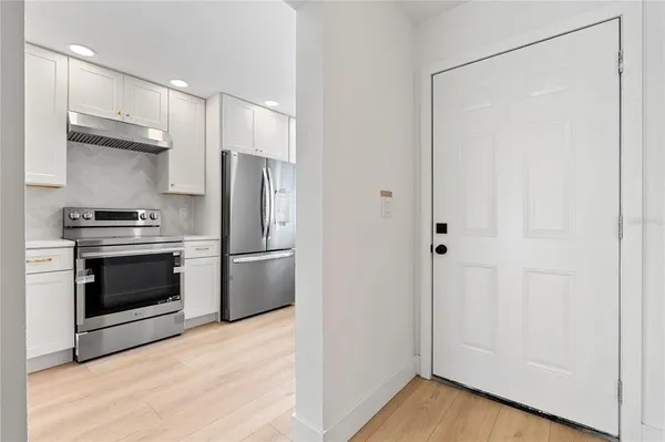 a kitchen with stainless steel appliances a refrigerator and a stove top oven