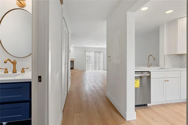 a en suite bathroom with a granite countertop sink and a mirror