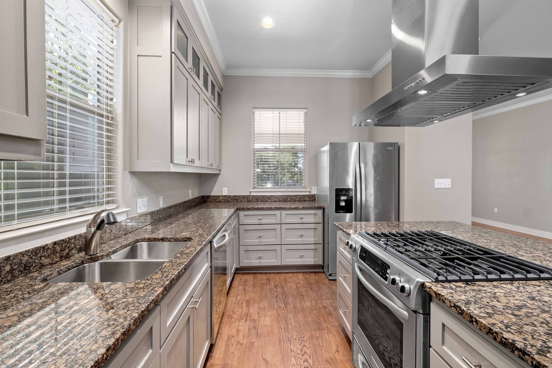 2309 A Longview Street, Unit A Austin, TX 78705 - Photo 5 of 13 a kitchen with stainless steel appliances granite countertop a sink stove and refrigerator