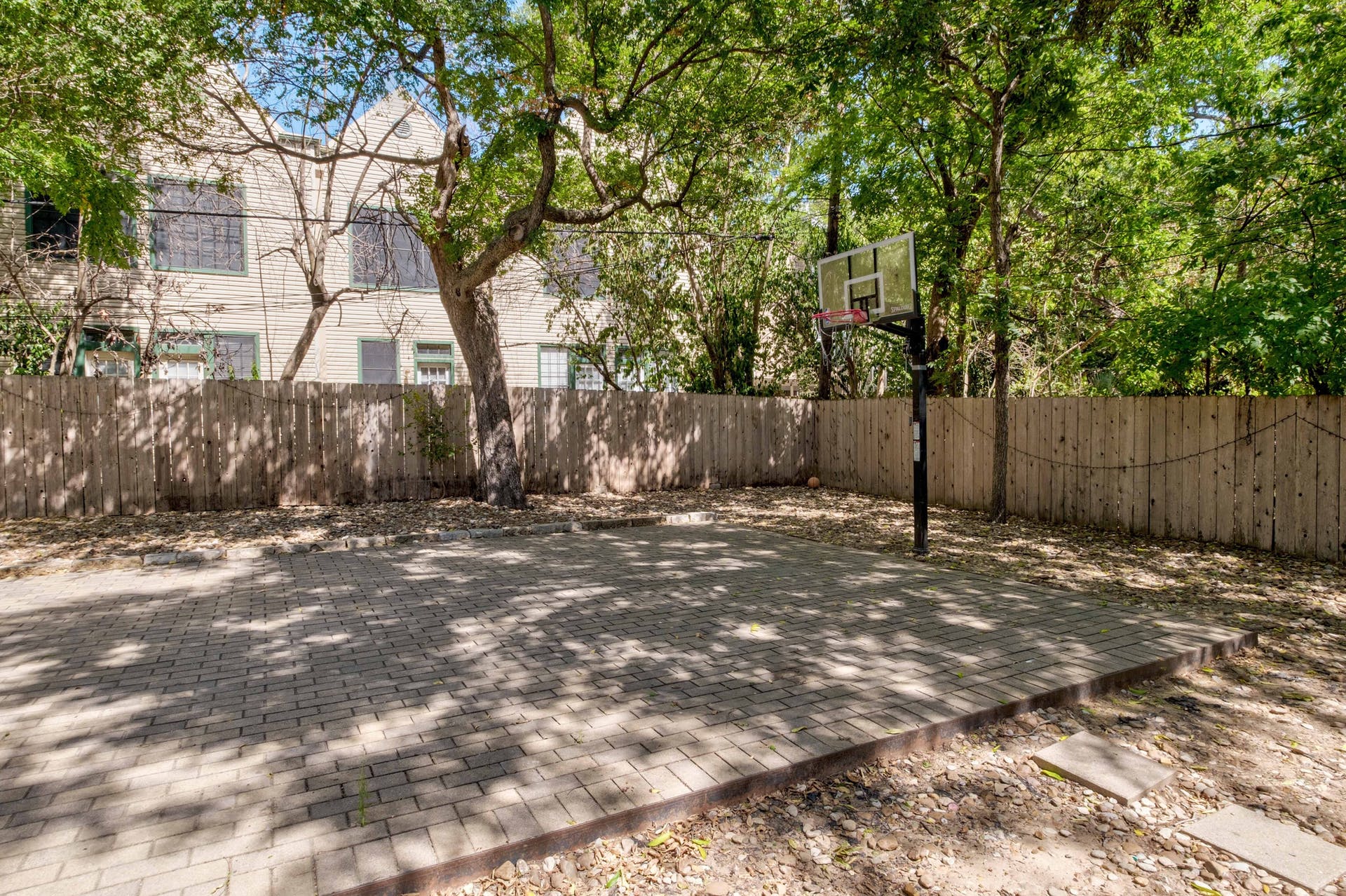 2309 A Longview Street, Unit A Austin, TX 78705 - Photo 9 of 13 a view of backyard with large trees and wooden fence