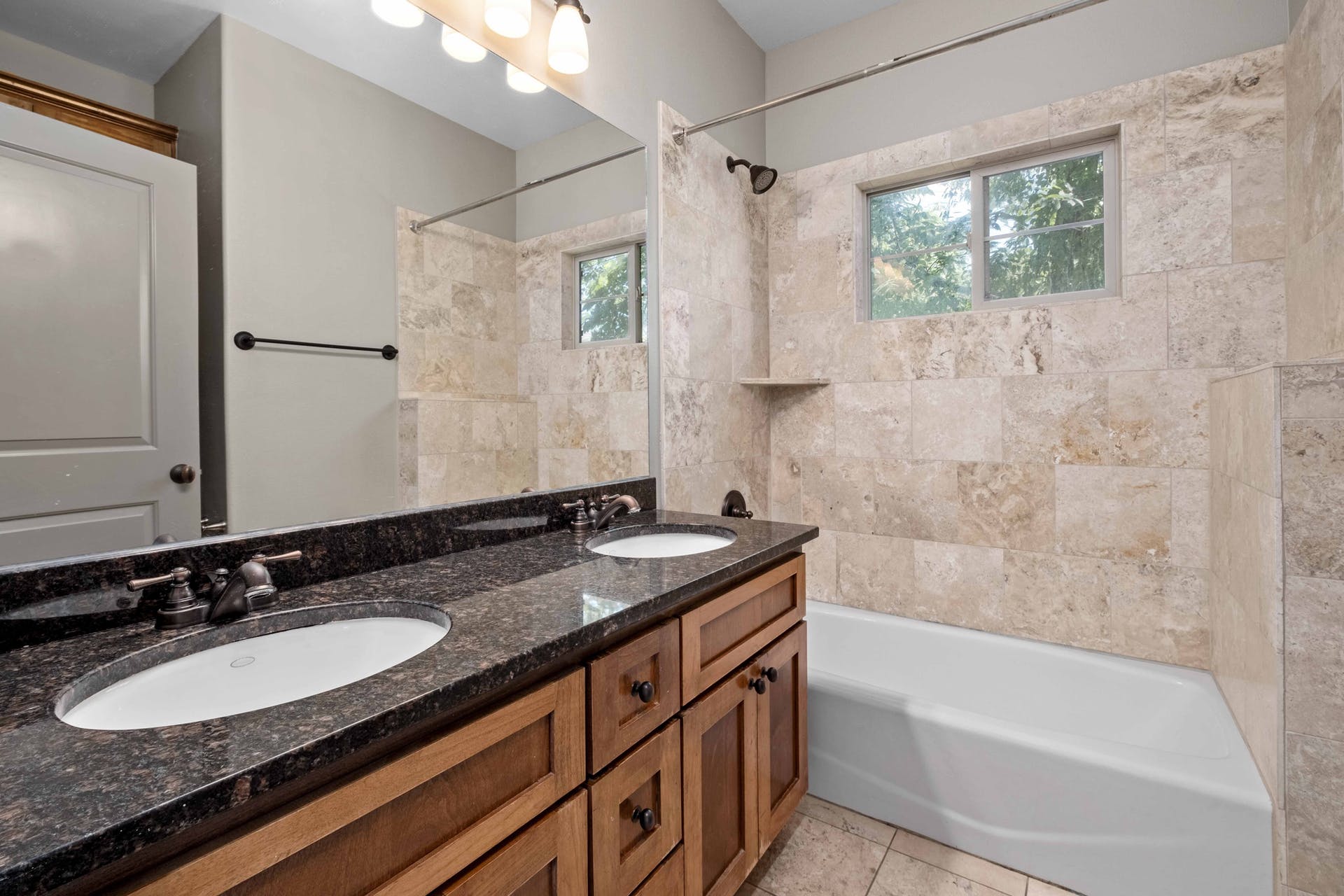 2309 A Longview Street, Unit A Austin, TX 78705 - Photo 10 of 13 a bathroom with a granite countertop sink mirror and a bathtub