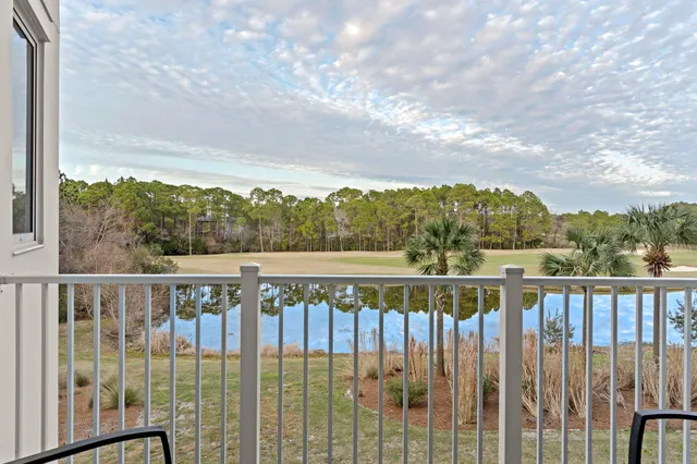 a living room with furniture a flat screen tv and a large window