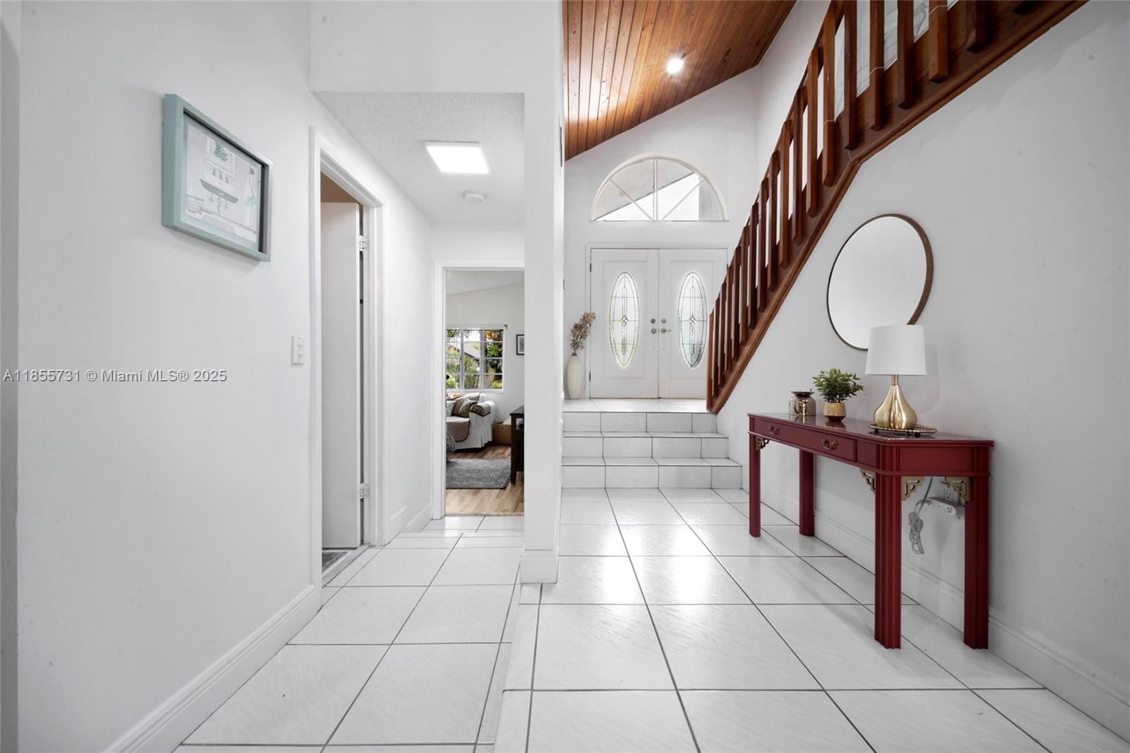 10723 Southwest 142nd Court Miami, FL 33186 - Photo 16 of 54 a view of a hallway with a flower pot and a bookshelf