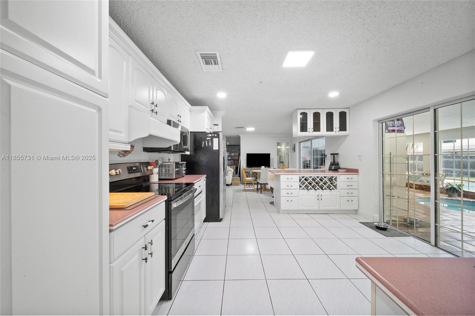 10723 Southwest 142nd Court Miami, FL 33186 - Photo 24 of 54 a large white kitchen with cabinets