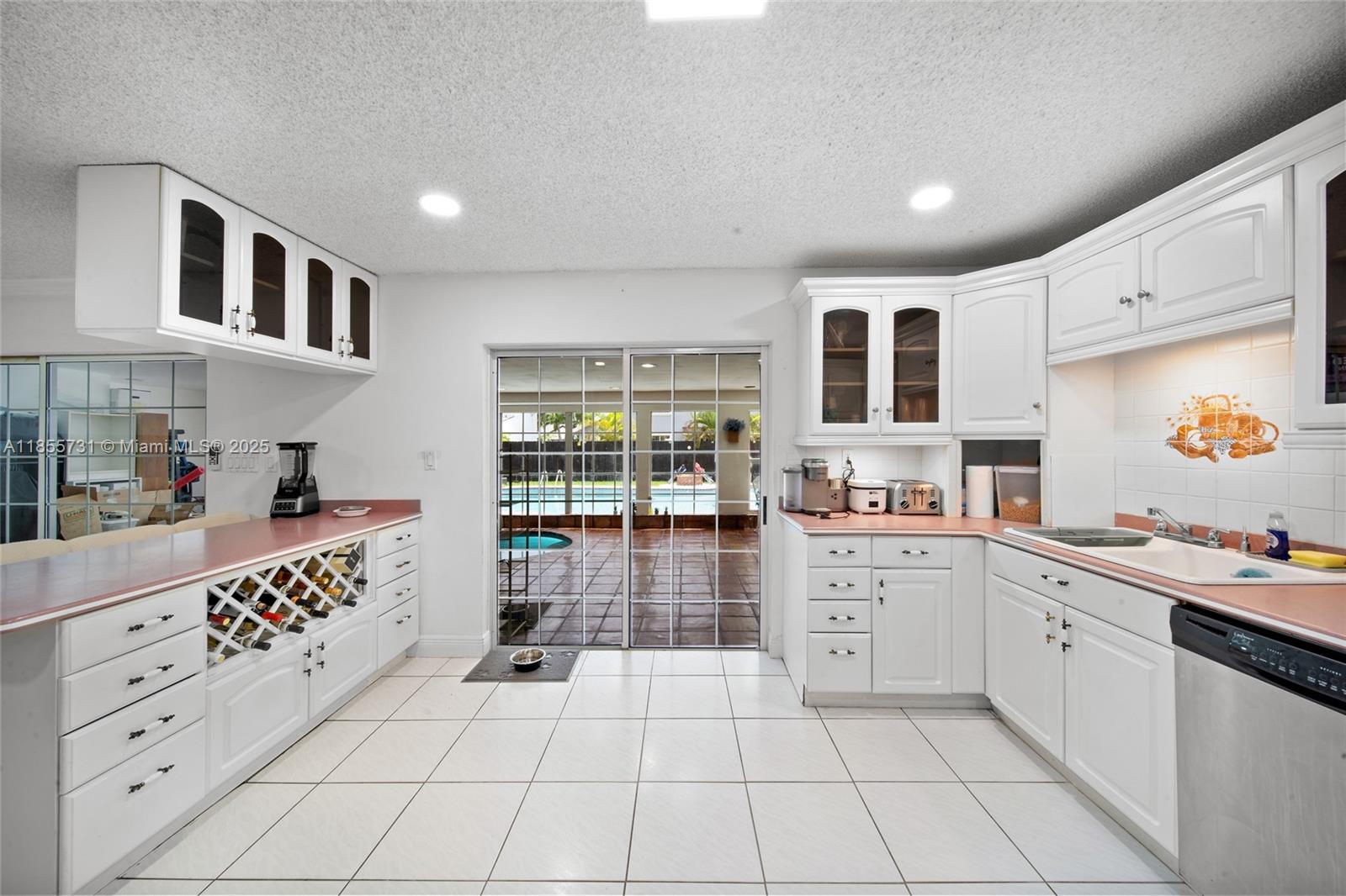10723 Southwest 142nd Court Miami, FL 33186 - Photo 26 of 54 a kitchen with stainless steel appliances a sink and cabinets