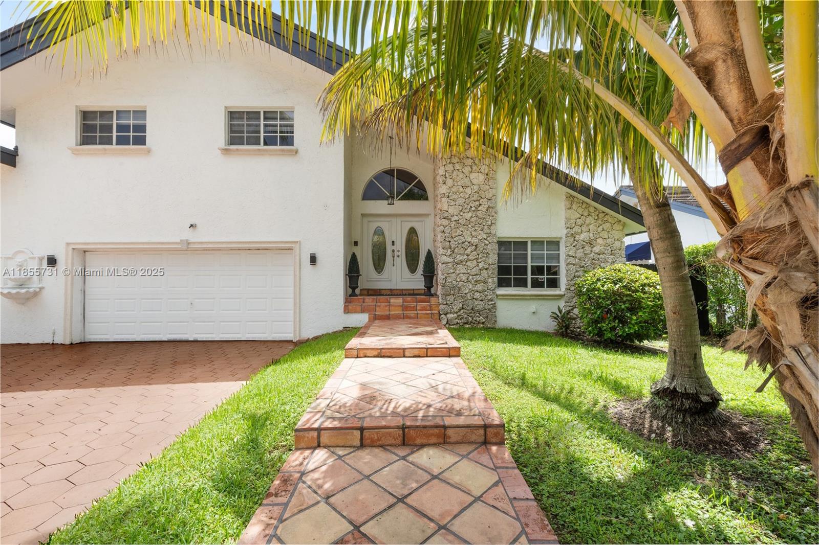 10723 Southwest 142nd Court Miami, FL 33186 - Photo 3 of 54 a front view of a house with a garden and plants