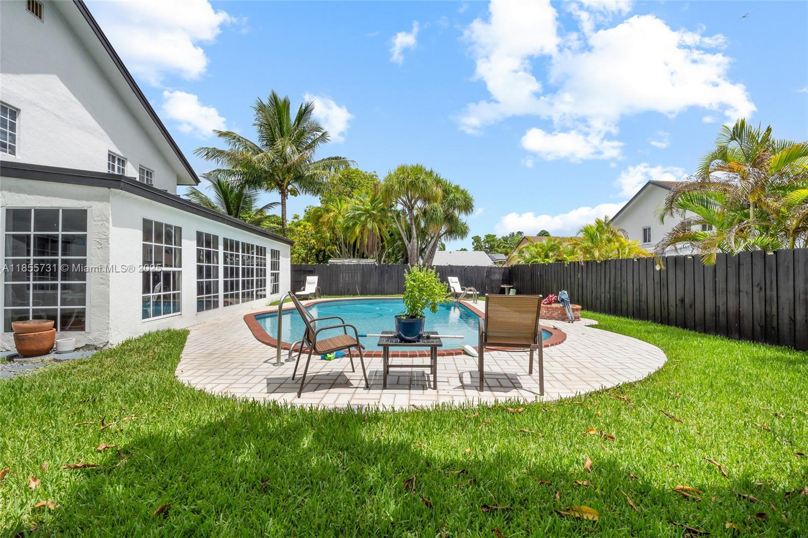 10723 Southwest 142nd Court Miami, FL 33186 - Photo 34 of 54 a view of a chair and table in backyard of the house