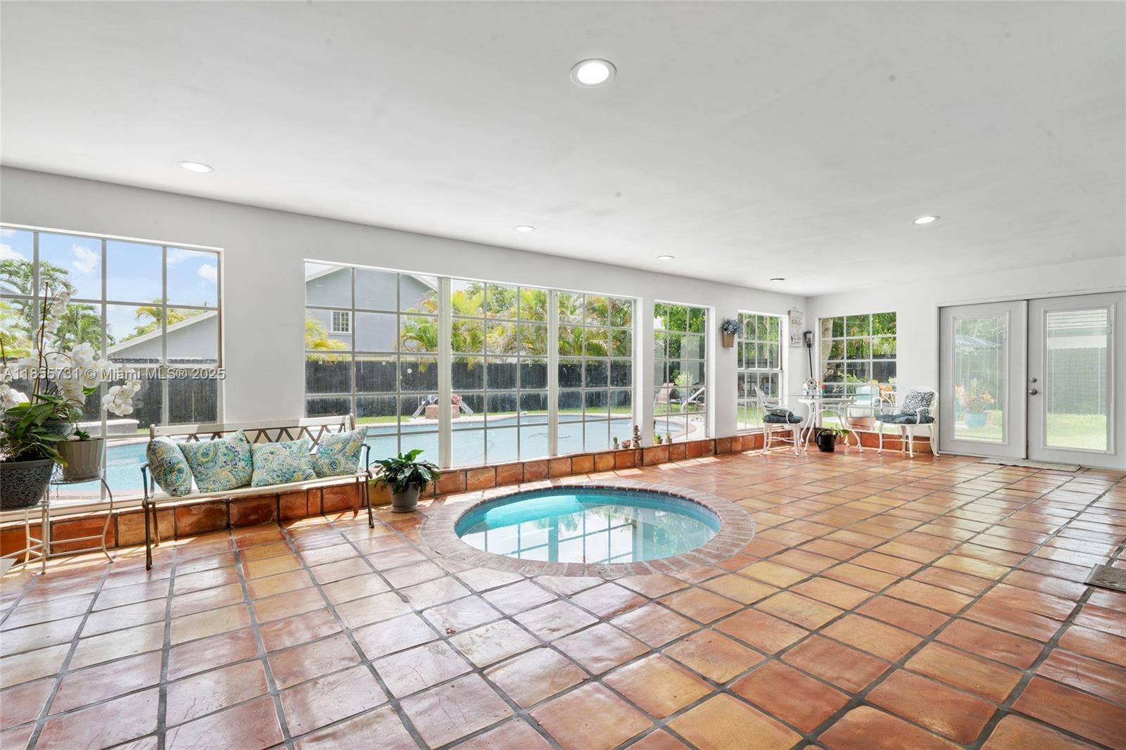 10723 Southwest 142nd Court Miami, FL 33186 - Photo 41 of 54 a swimming pool with outdoor seating and yard