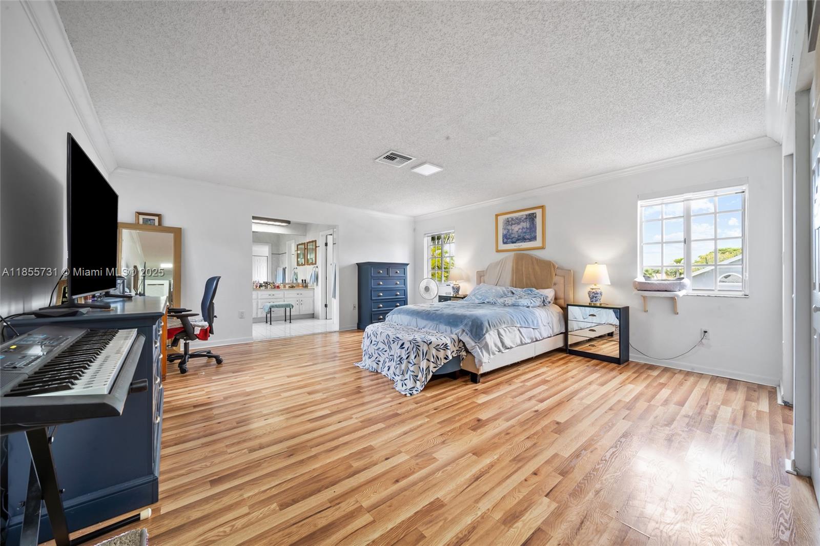 10723 Southwest 142nd Court Miami, FL 33186 - Photo 43 of 54 a spacious bedroom with a bed and wooden floor