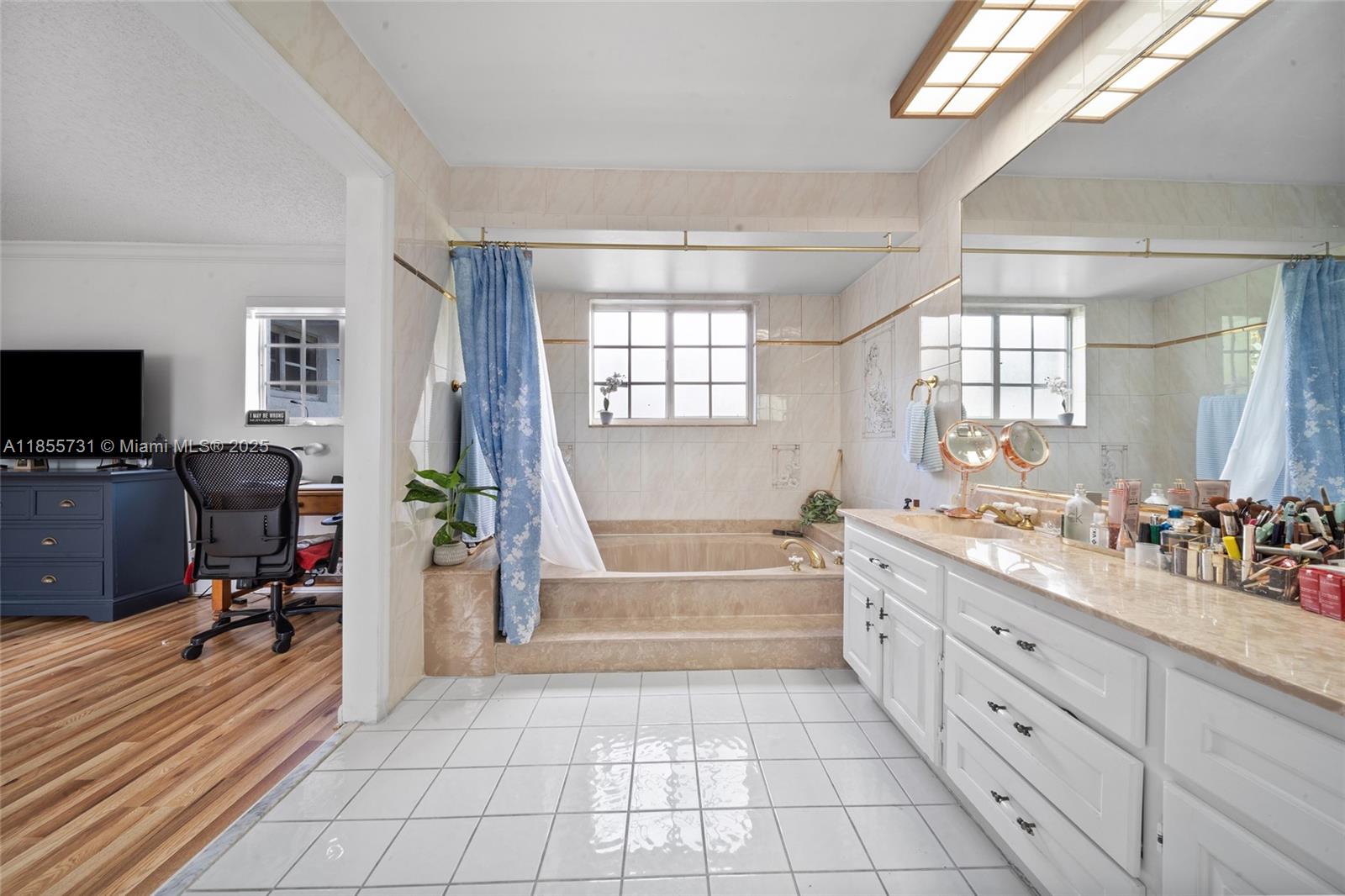 10723 Southwest 142nd Court Miami, FL 33186 - Photo 46 of 54 a spacious bathroom with a double vanity sink a mirror and a bathtub