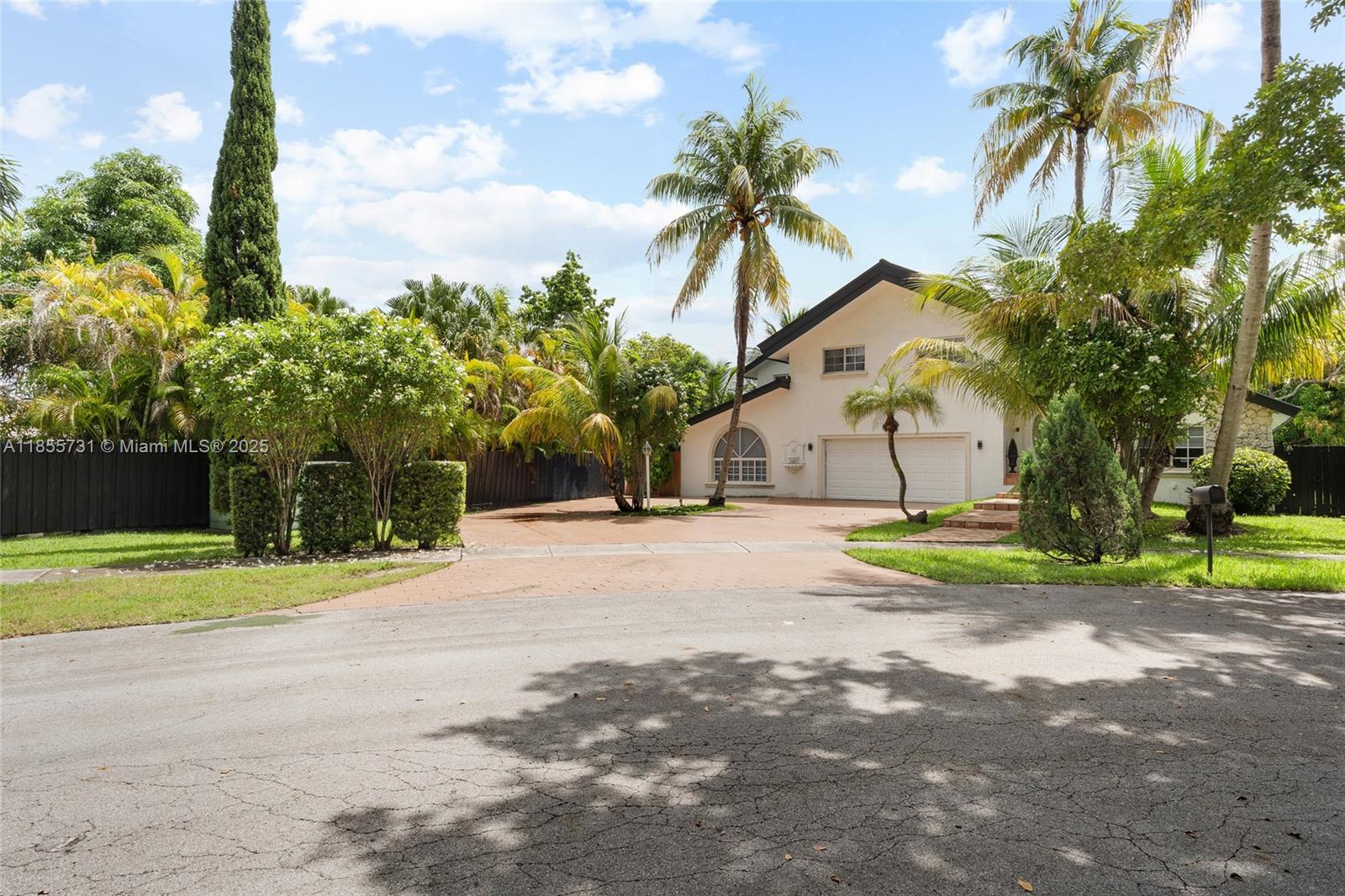 10723 Southwest 142nd Court Miami, FL 33186 - Photo 5 of 54 a view of a house with a yard and palm trees
