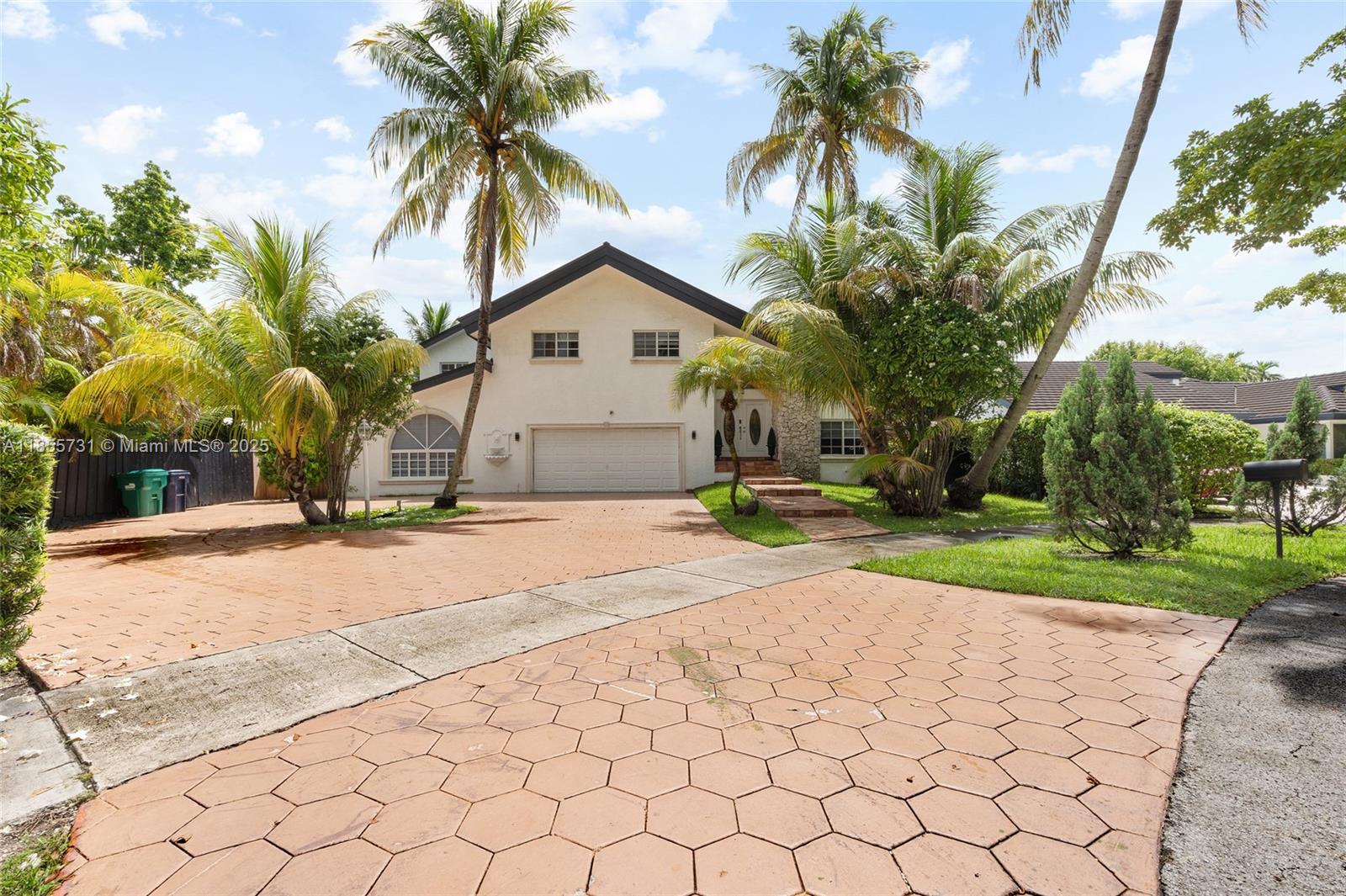 10723 Southwest 142nd Court Miami, FL 33186 - Photo 6 of 54 a view of a house with a yard and coconut trees