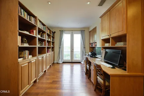 a bedroom with furniture and large windows