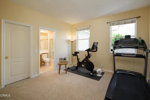 a living room with furniture a large window and a flat screen tv