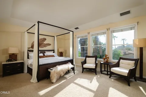 a couple of palm trees sitting in front of a house