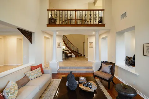 a dining room with furniture window and wooden floor
