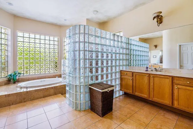 a spacious bathroom with a bathtub and a sink